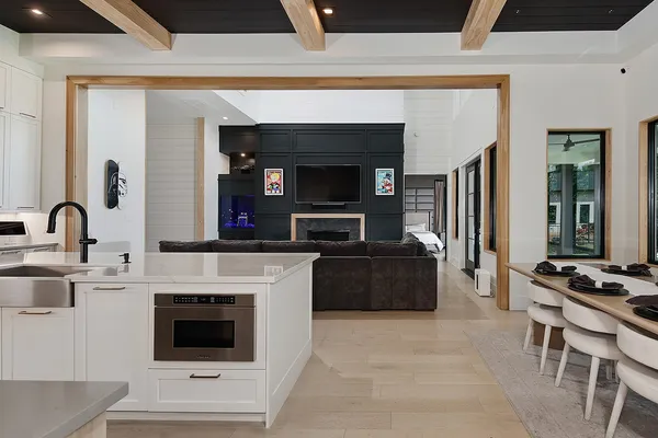 a living room with furniture a fireplace and flat screen tv