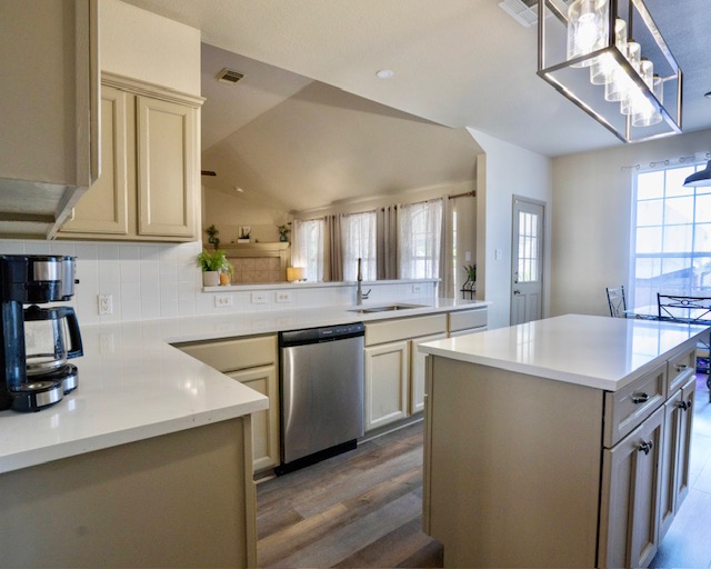 1406 Apache Cove Pflugerville, TX 78660 - Photo 11 of 40 a kitchen with kitchen island a sink stove and cabinets