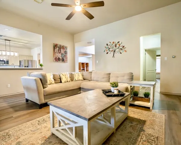a living room with furniture and a chandelier