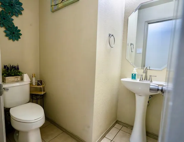 a bathroom with a sink toilet and a mirror