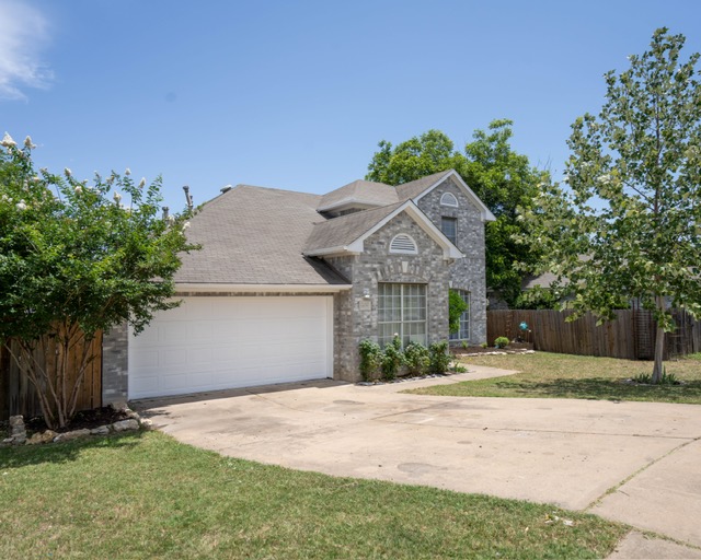 1406 Apache Cove Pflugerville, TX 78660 - Photo 2 of 40 front view of a house with a yard