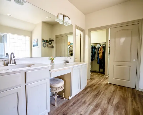 a kitchen with a refrigerator sink and cabinets