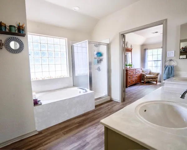 a spacious bathroom with a tub and mirror