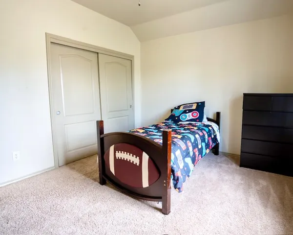 a bedroom with a bed and a closet