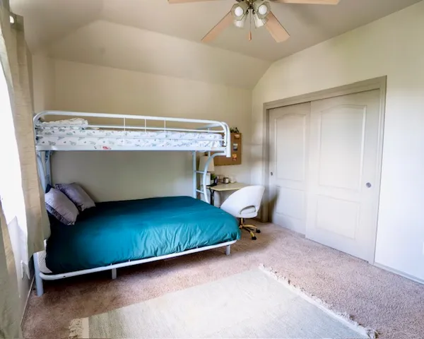 a living room with a bed and a chandelier
