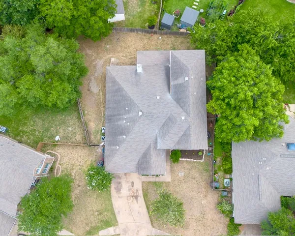 an aerial view of a house with a garden and yard