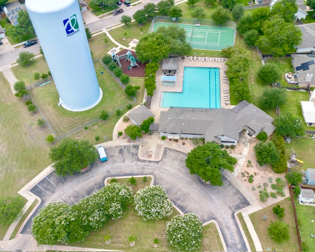 1406 Apache Cove Pflugerville, TX 78660 - Photo 38 of 40 an aerial view of a house with a swimming pool and garden