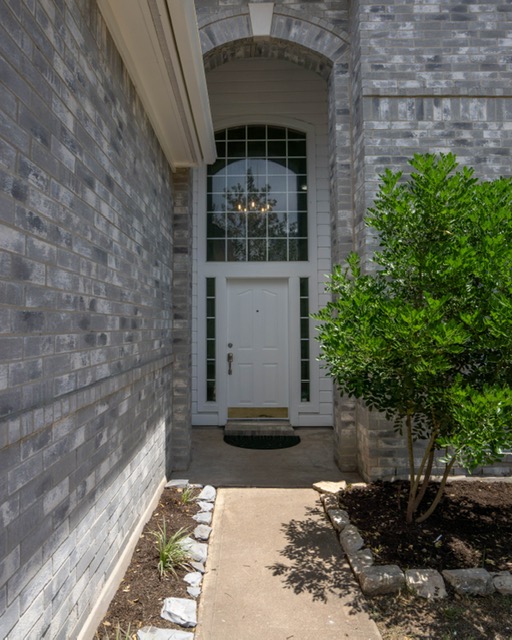 1406 Apache Cove Pflugerville, TX 78660 - Photo 4 of 40 a front view of a house with a yard