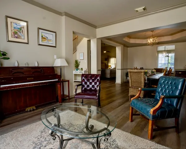a living room with furniture and wooden floor