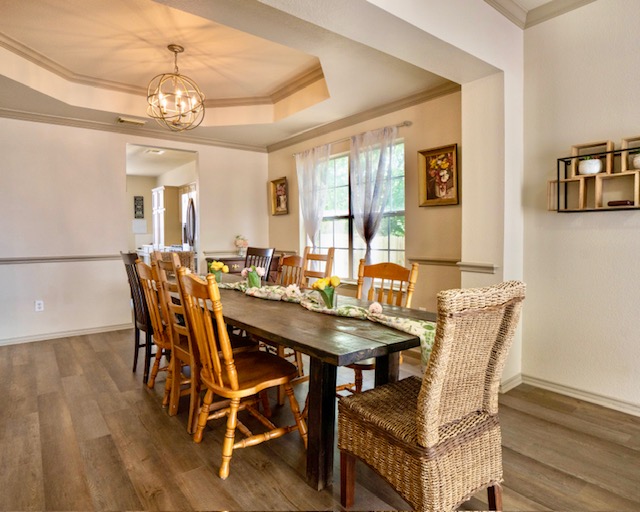 1406 Apache Cove Pflugerville, TX 78660 - Photo 9 of 40 a view of a dining room with furniture and wooden floor