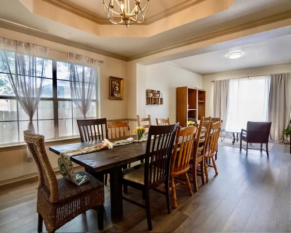 a view of a dining room with furniture window and wooden floor