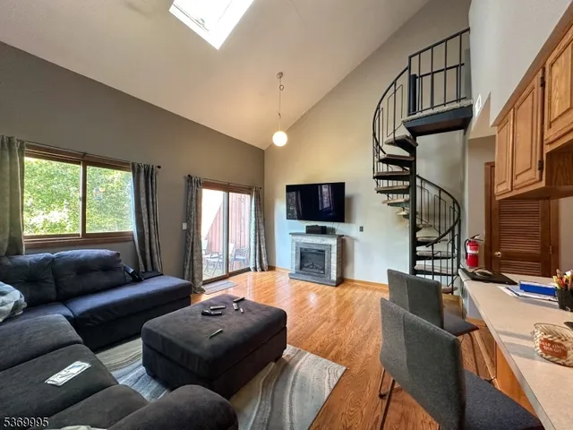 a living room with furniture tv and a window