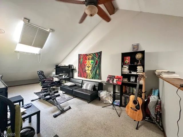 a room with gym equipment and a view of living room