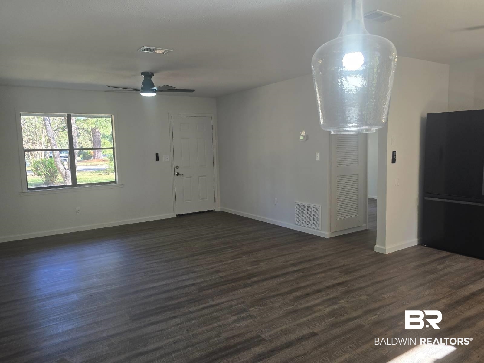 1404 Dailey Street Brewton, AL 36426 - Photo 7 of 25 Unfurnished living room featuring dark wood finished floors and ceiling fan