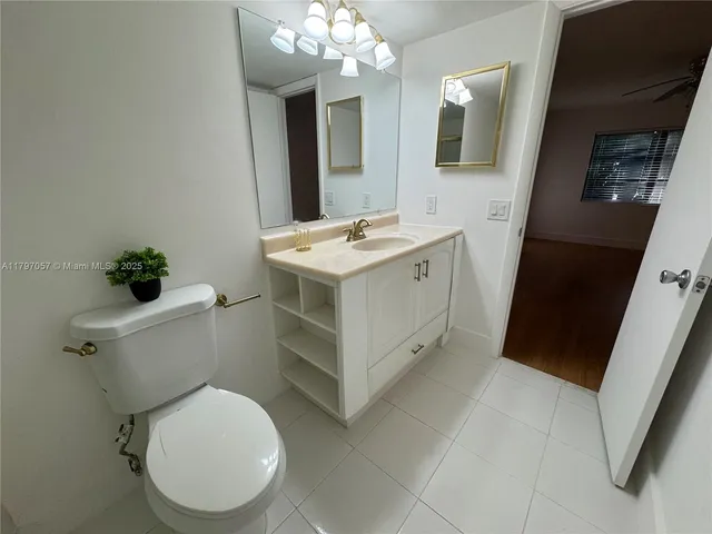 a white toilet sitting next to a bathroom sink