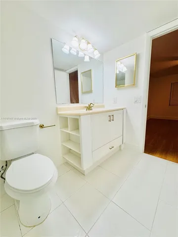 a bathroom with a sink a mirror and a toilet