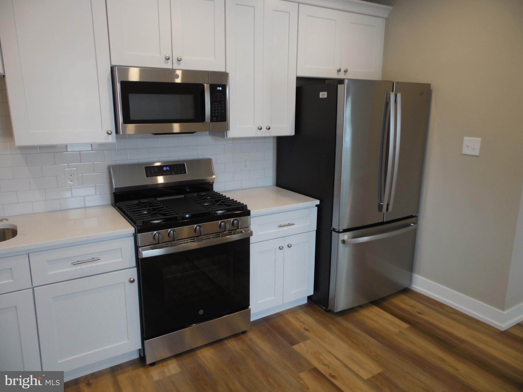 155 Channing Avenue, Unit 3 Malvern, PA 19355 - Photo 13 of 16 a kitchen with a refrigerator stove and microwave