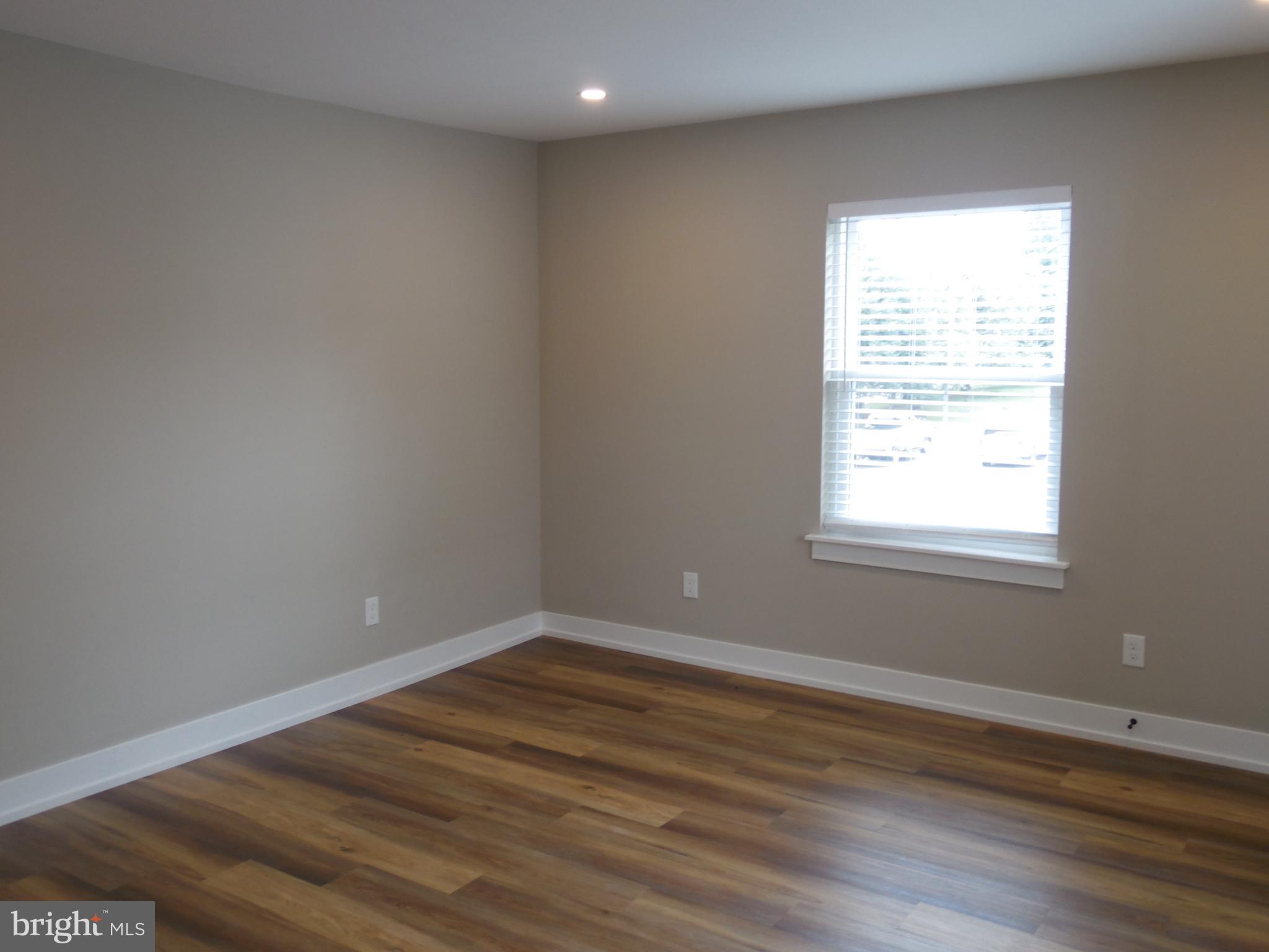155 Channing Avenue, Unit 3 Malvern, PA 19355 - Photo 3 of 16 a view of a room with wooden floor and windows in it