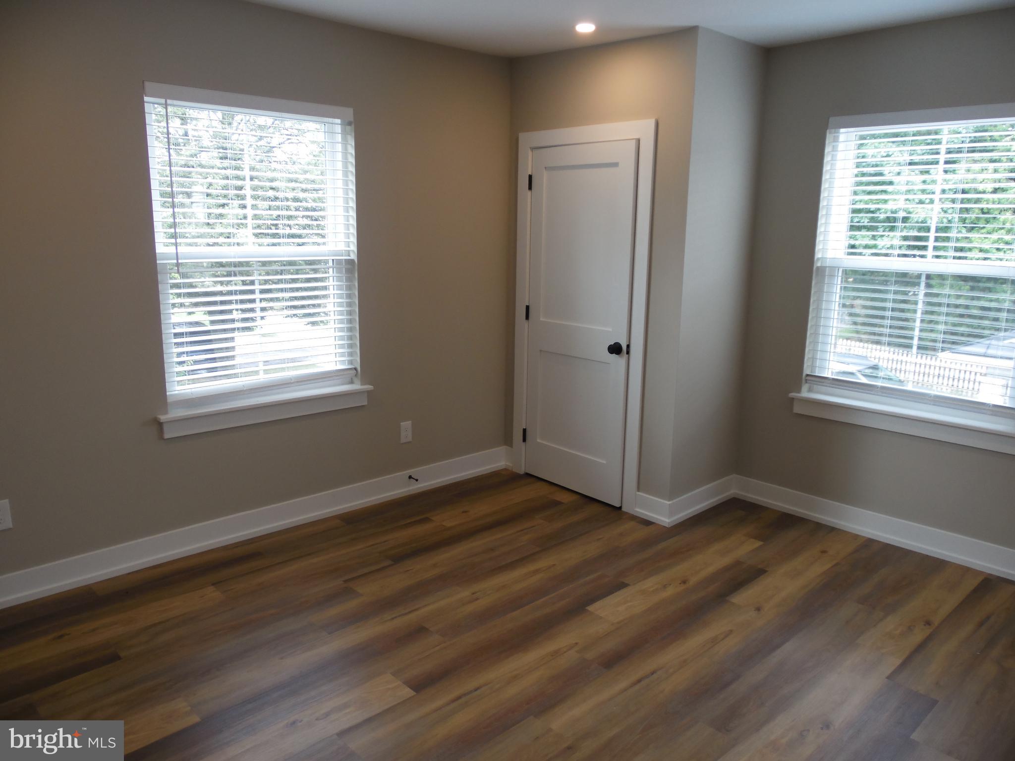 155 Channing Avenue, Unit 3 Malvern, PA 19355 - Photo 4 of 16 a view of an empty room with wooden floor and a window