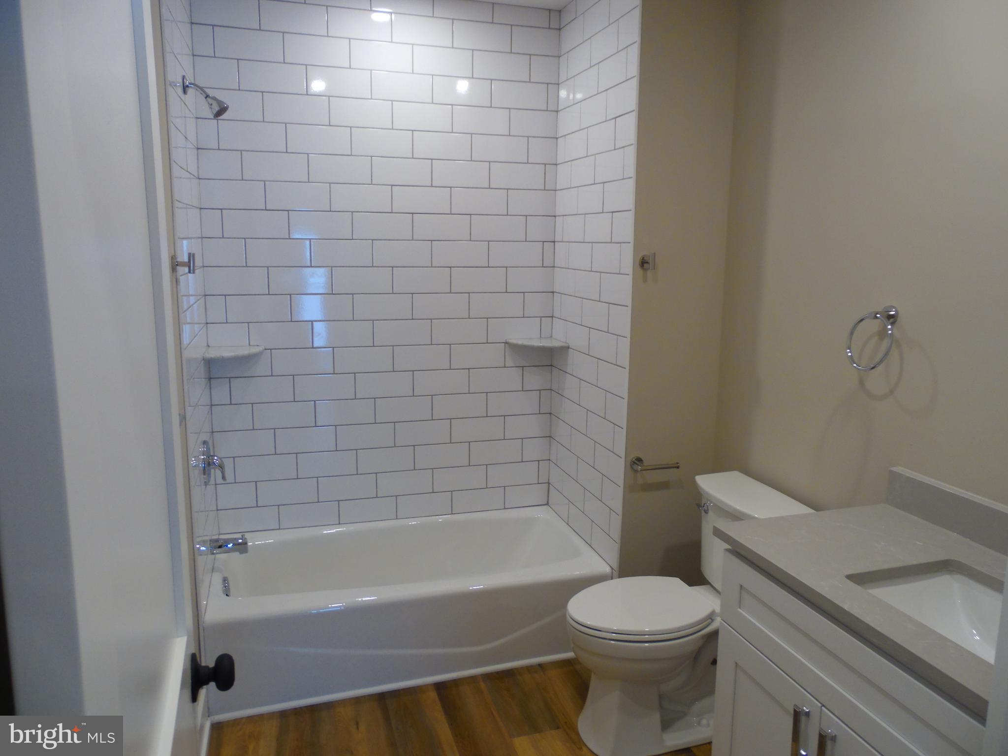 155 Channing Avenue, Unit 3 Malvern, PA 19355 - Photo 9 of 16 a bathroom with a toilet and a bath tub