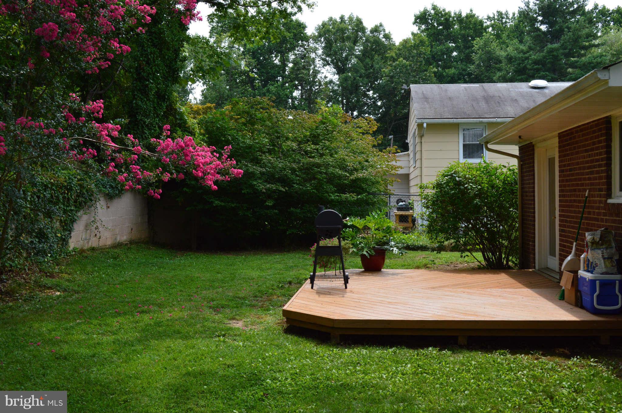 5916 Atteentee Road Springfield, VA 22150 - Photo 21 of 24 a view of a house with a yard patio and a garden