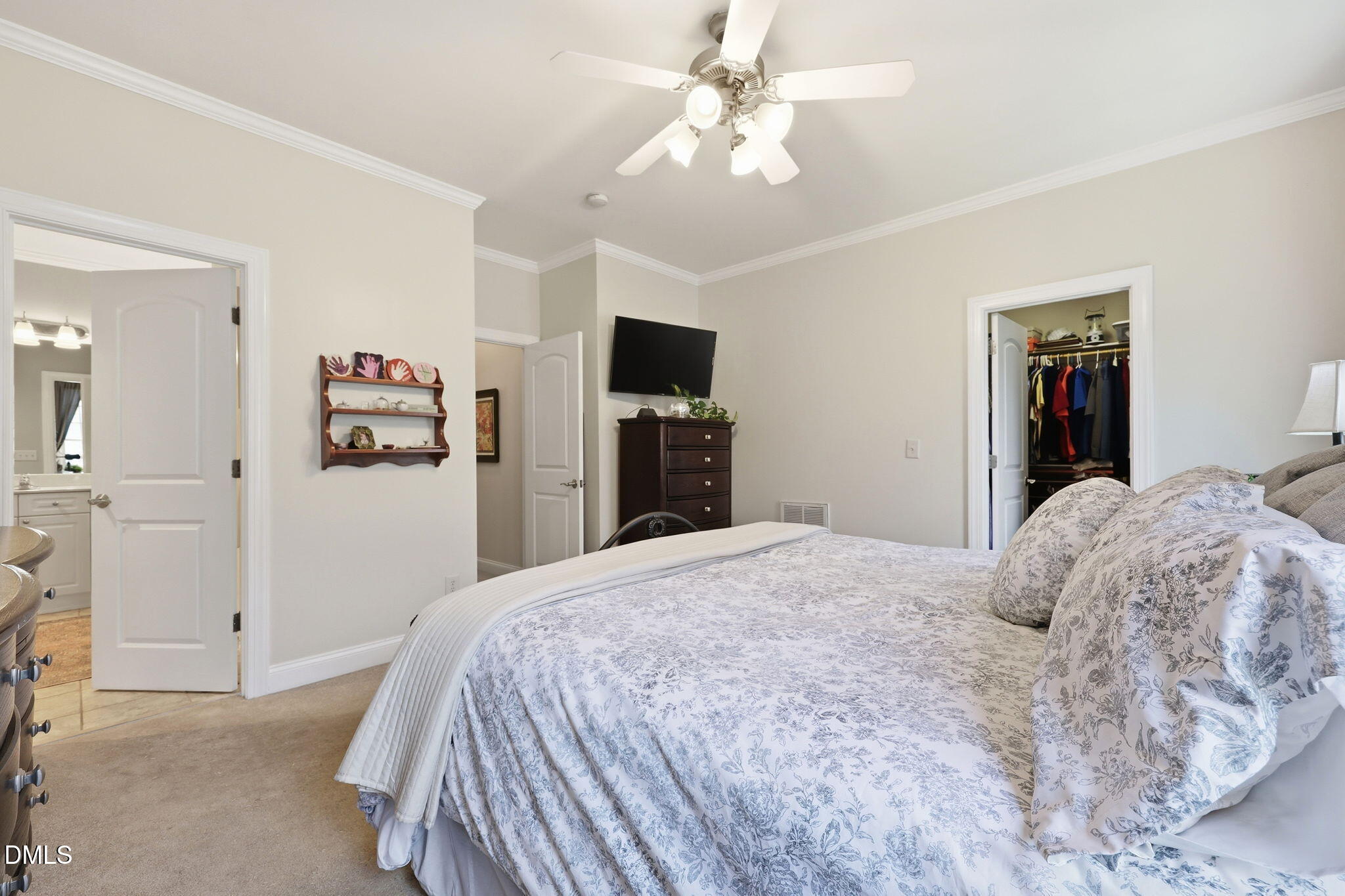 7040 Dayton Ridge Drive Apex, NC 27539 - Photo 20 of 38 a bedroom with a bed and a flat tv screen on dresser