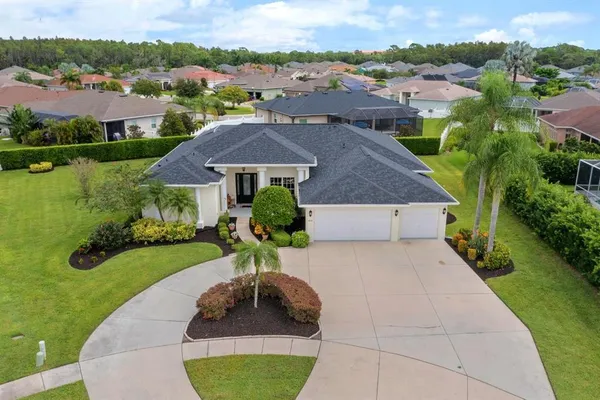 an aerial view of a house with yard swimming pool and outdoor seating
