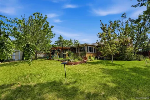 a backyard of a house with table and chairs