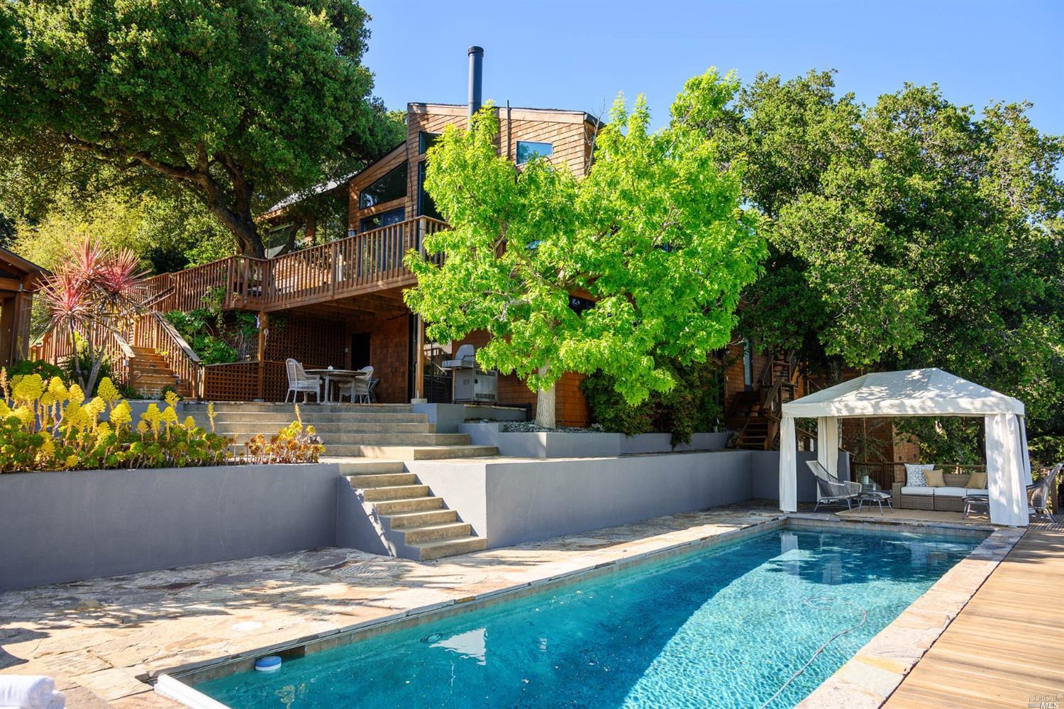 a view of a house with backyard and sitting area