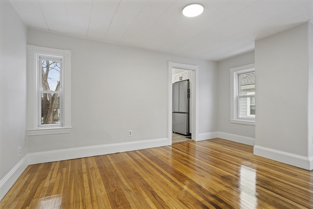 135 Cottage Street, Unit 2 Norwood, MA 02062 - Photo 11 of 30 a view of an empty room with wooden floor and a window