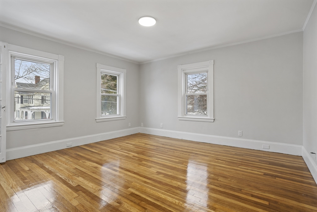 135 Cottage Street, Unit 2 Norwood, MA 02062 - Photo 15 of 30 a view of an empty room with wooden floor and a window