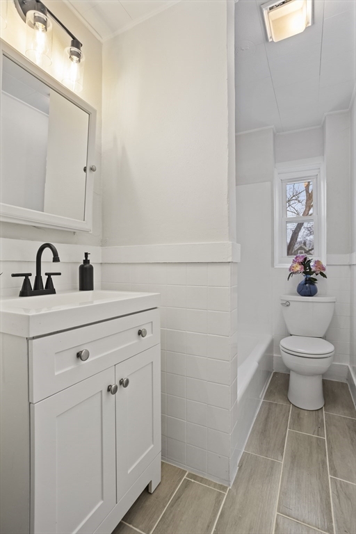 135 Cottage Street, Unit 2 Norwood, MA 02062 - Photo 24 of 30 a bathroom with a toilet sink and mirror