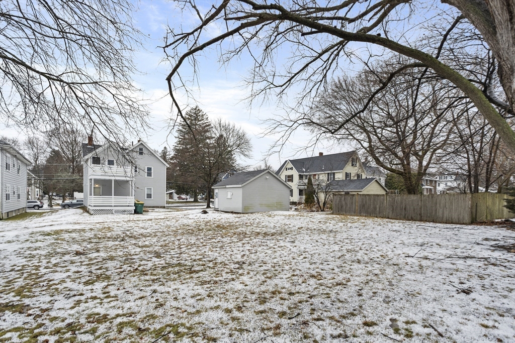 135 Cottage Street, Unit 2 Norwood, MA 02062 - Photo 27 of 30 a white house that has a tree in front of it