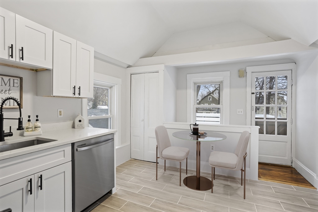 135 Cottage Street, Unit 2 Norwood, MA 02062 - Photo 6 of 30 a kitchen with stainless steel appliances a sink and cabinets
