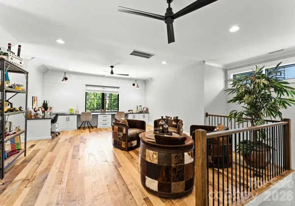 a living room with furniture a couch and a potted plant