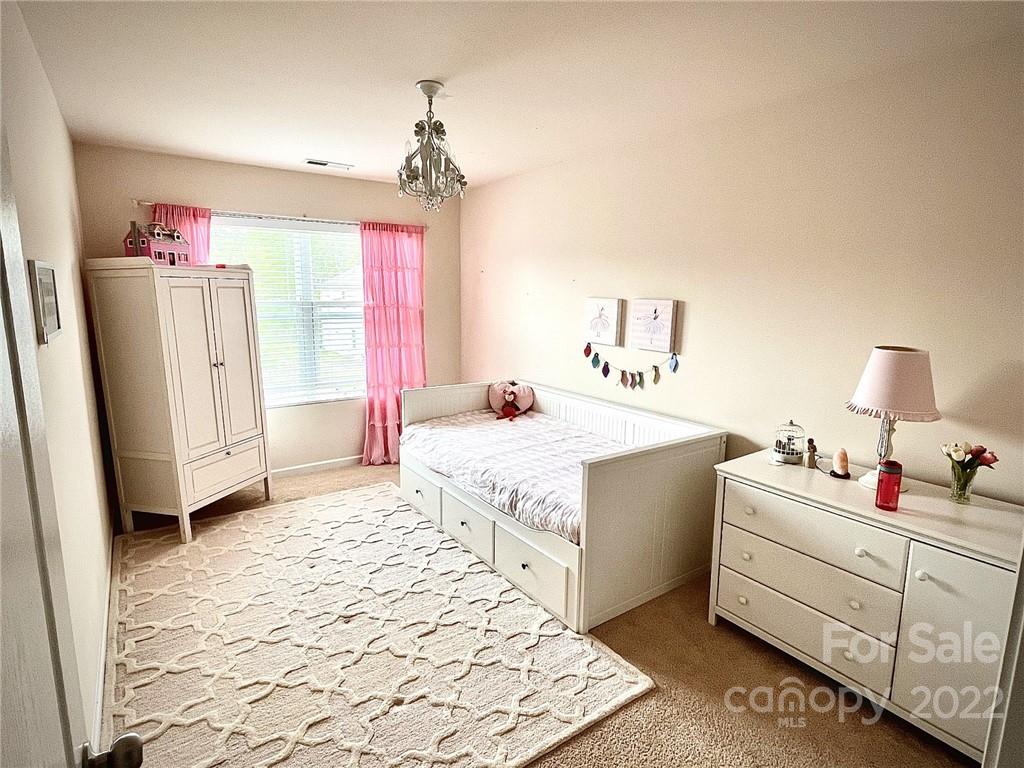 7402 Cedarfield Road Charlotte, NC 28227 - Photo 12 of 15 a bedroom with a bed dresser and a window