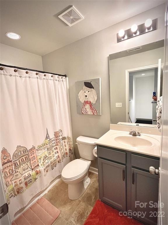 7402 Cedarfield Road Charlotte, NC 28227 - Photo 13 of 15 a bathroom with a toilet sink and mirror
