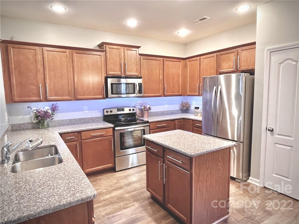 7402 Cedarfield Road Charlotte, NC 28227 - Photo 5 of 15 a kitchen with a sink stove and refrigerator