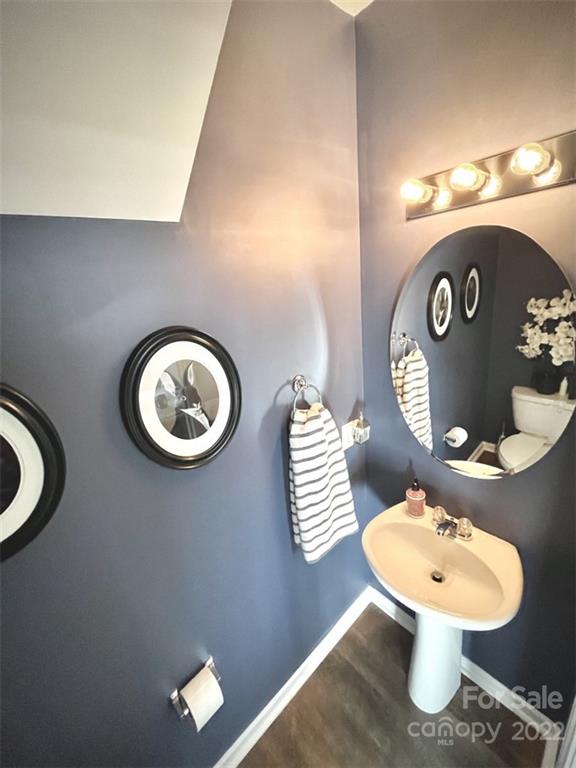 7402 Cedarfield Road Charlotte, NC 28227 - Photo 7 of 15 a bathroom with a toilet a sink and a mirror