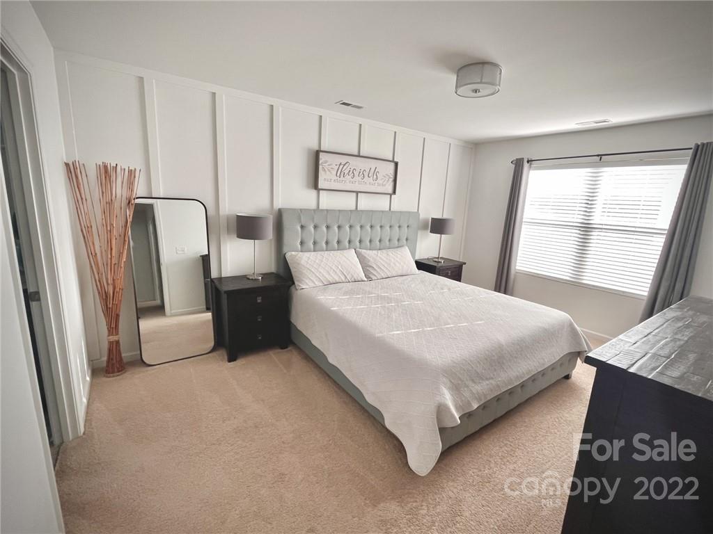7402 Cedarfield Road Charlotte, NC 28227 - Photo 8 of 15 a bedroom with a bed painting and a window