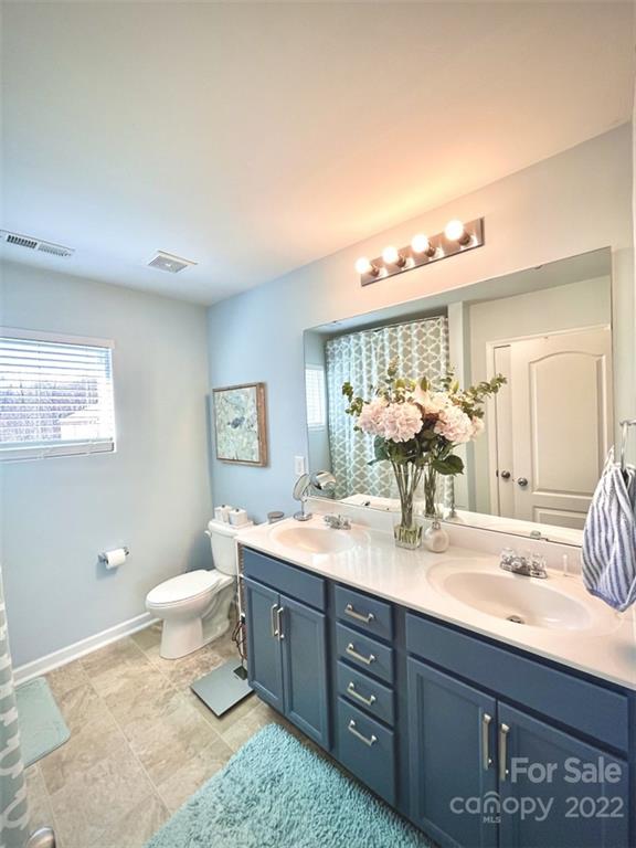 7402 Cedarfield Road Charlotte, NC 28227 - Photo 9 of 15 a bathroom with a double vanity sink mirror and toilet
