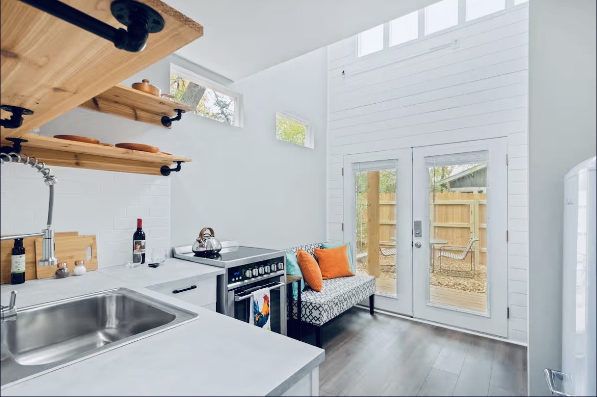 307 East 35th Street, Unit A Austin, TX 78705 - Photo 24 of 31 Functional kitchen offers ample storage and direct access to an enclosed outdoor area, perfect for small gatherings.