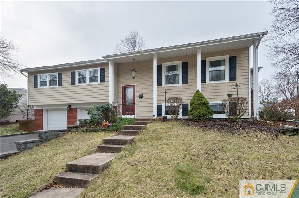 69 Wilk Road Edison, NJ 08837 - Photo 1 of 19 a front view of a house with garden