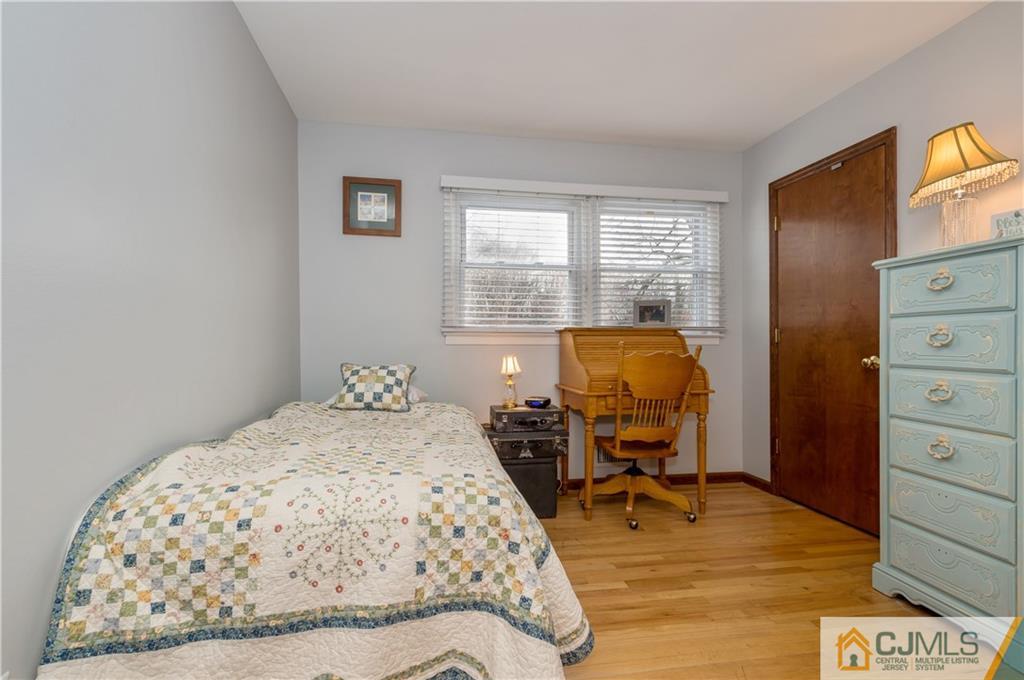 69 Wilk Road Edison, NJ 08837 - Photo 12 of 19 a bedroom with a bed and wooden floor