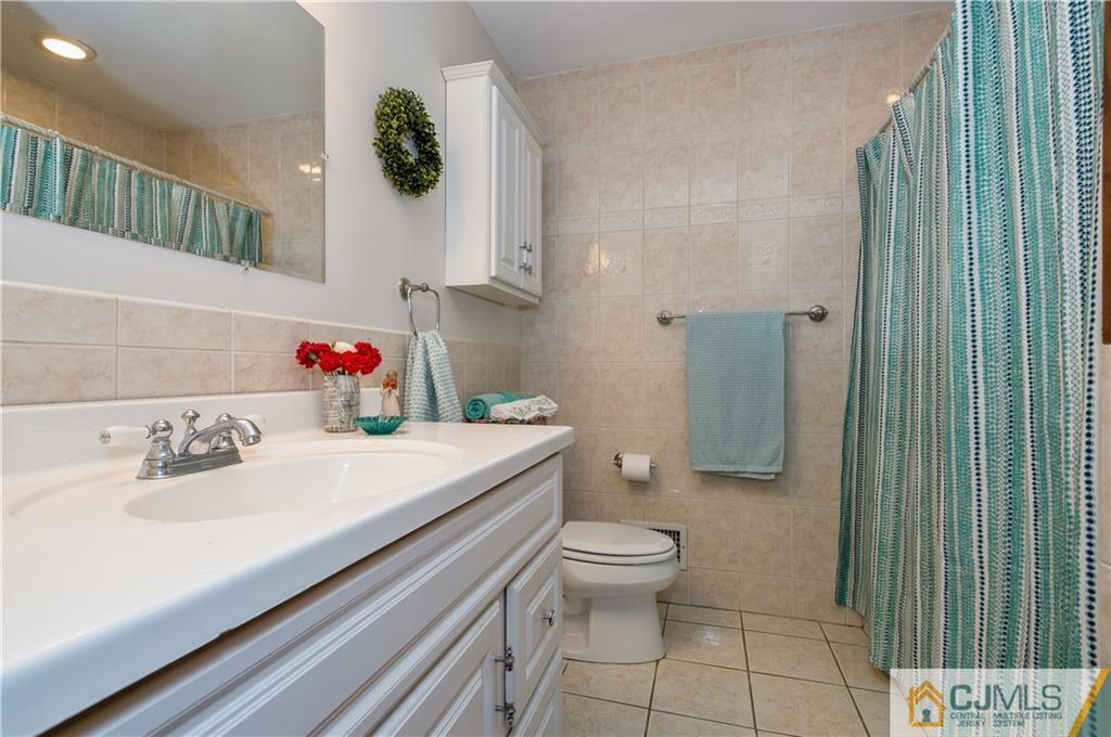69 Wilk Road Edison, NJ 08837 - Photo 14 of 19 a bathroom with a sink toilet and shower