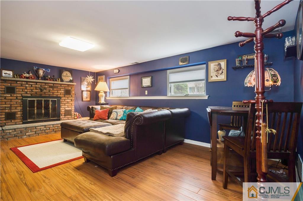 69 Wilk Road Edison, NJ 08837 - Photo 15 of 19 a living room with furniture and a fireplace