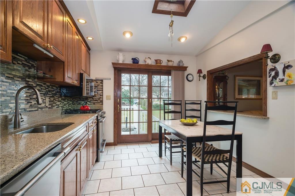 69 Wilk Road Edison, NJ 08837 - Photo 5 of 19 a kitchen with stainless steel appliances granite countertop a sink and a refrigerator