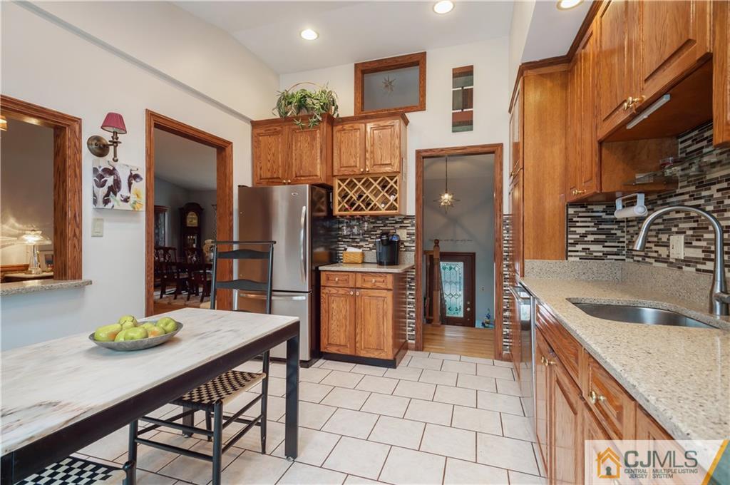 69 Wilk Road Edison, NJ 08837 - Photo 6 of 19 a kitchen with refrigerator and cabinets