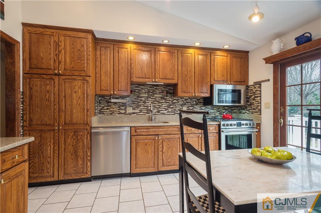 69 Wilk Road Edison, NJ 08837 - Photo 7 of 19 a kitchen with stainless steel appliances a stove sink and cabinets