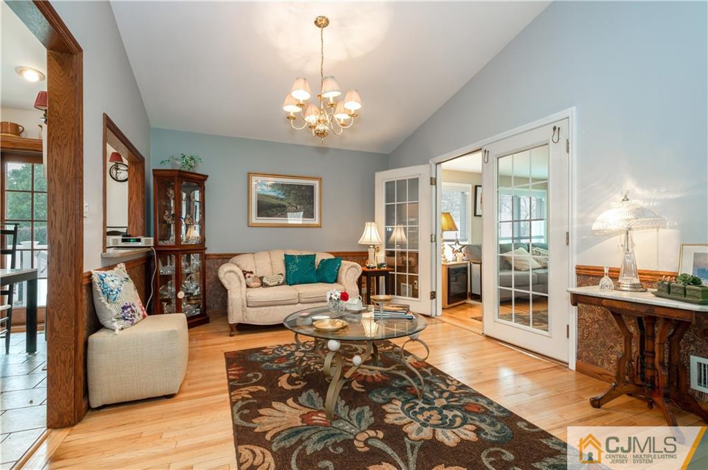 69 Wilk Road Edison, NJ 08837 - Photo 8 of 19 a living room with furniture and a chandelier